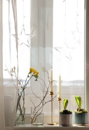 Photo of Potted hyacinths and freesias on window sill indoors, space for text. First spring flowers
