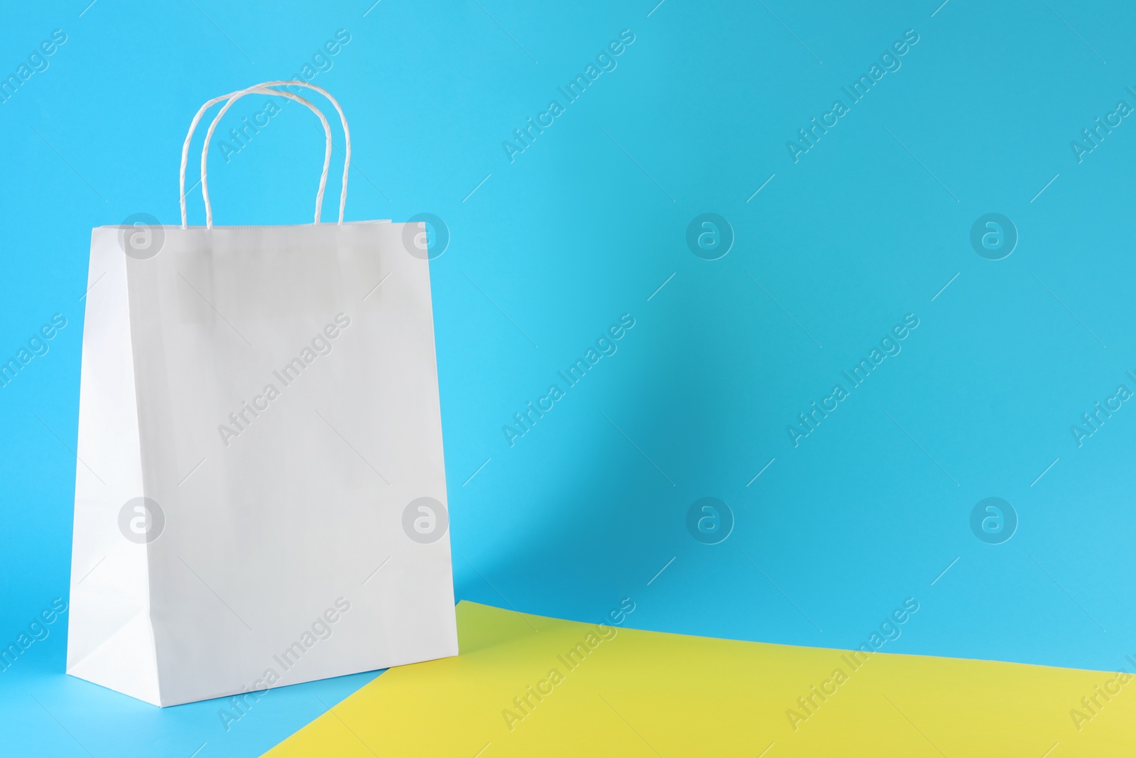 Photo of One paper bag on color background, space for text