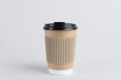 Photo of Paper cup with plastic lid on light background. Coffee to go