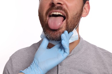 Photo of Doctor examining man`s oral cavity on white background, closeup