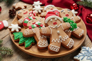 Delicious Christmas cookies and festive decor on wooden table, closeup