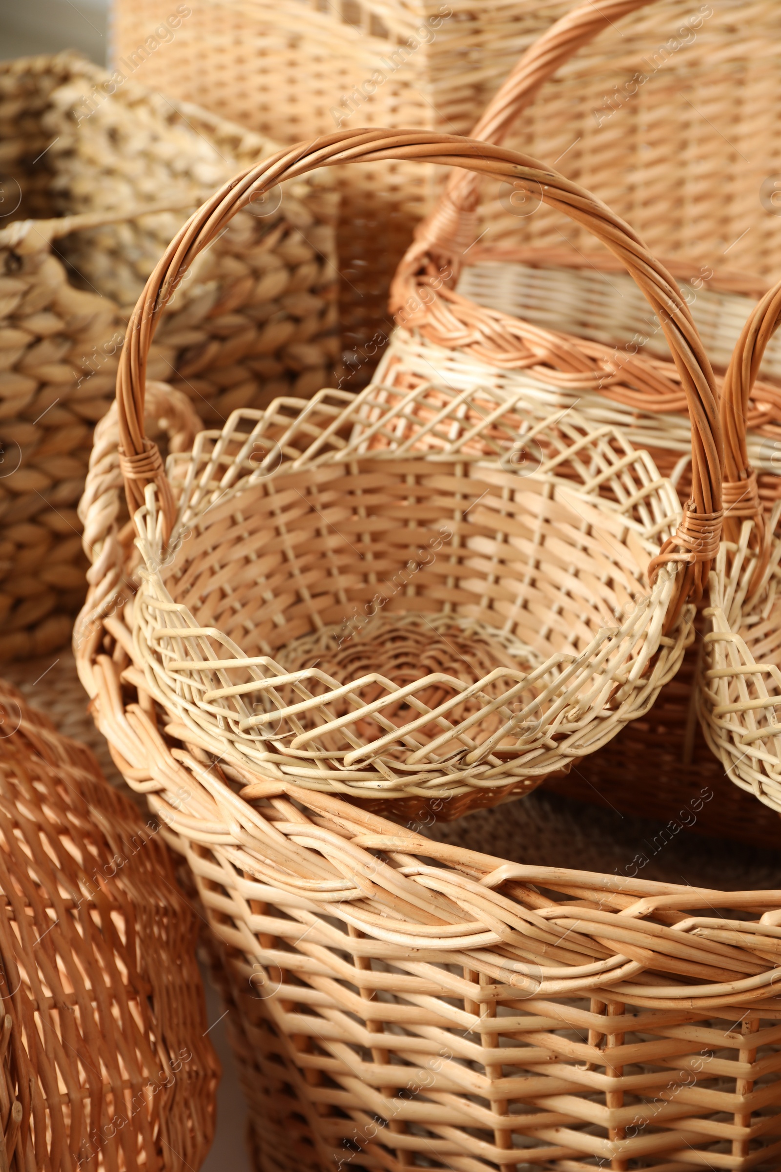 Photo of Many different wicker baskets made of natural material as background