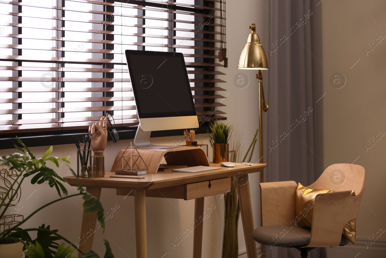 Photo of Stylish room interior with modern workplace at window