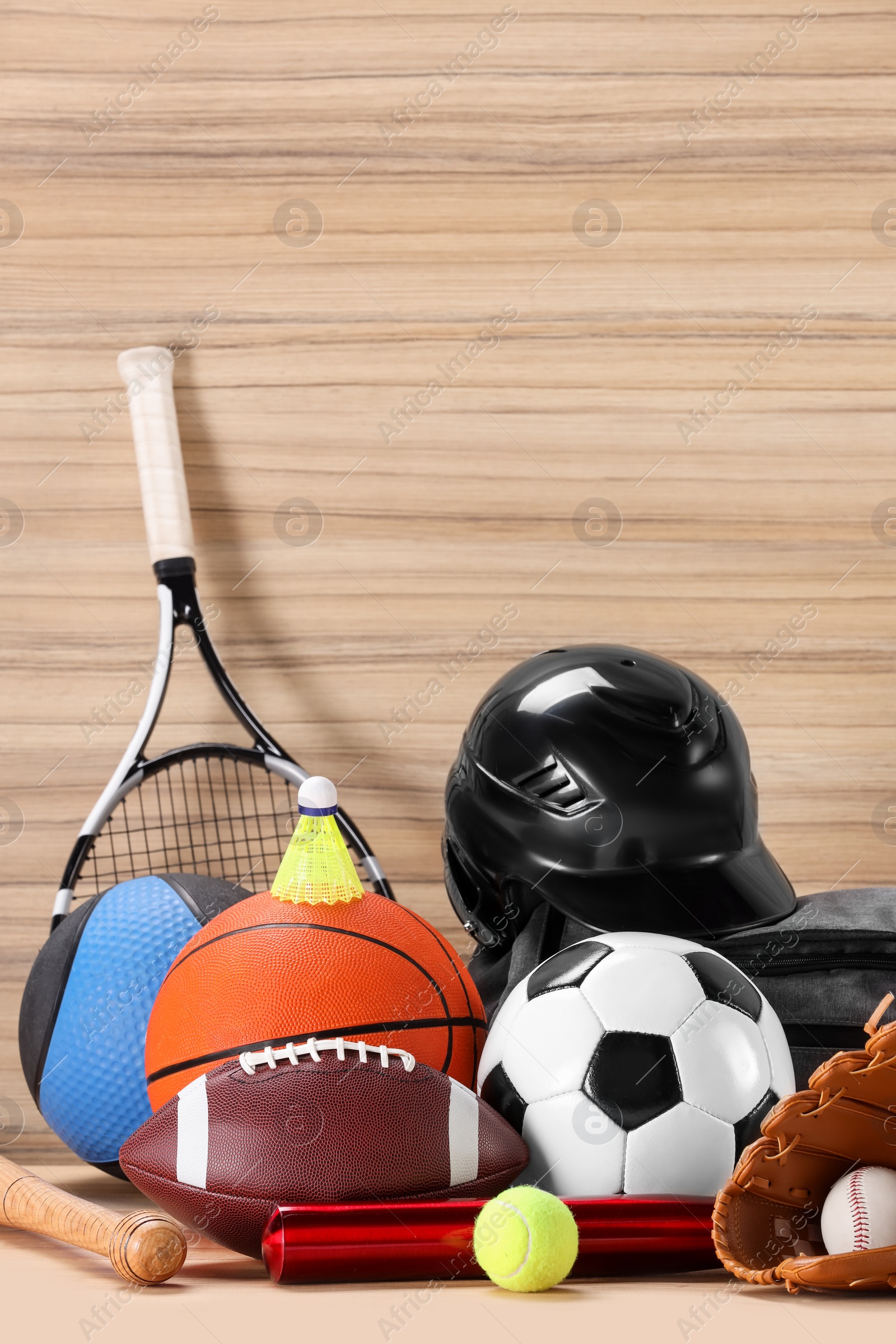 Photo of Many different sports equipment on wooden table