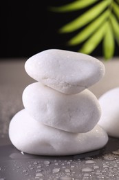 Photo of White spa stones with water drops on grey background