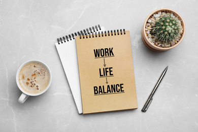 Work-life balance concept. Flat lay composition with notebooks and cup of coffee on grey background