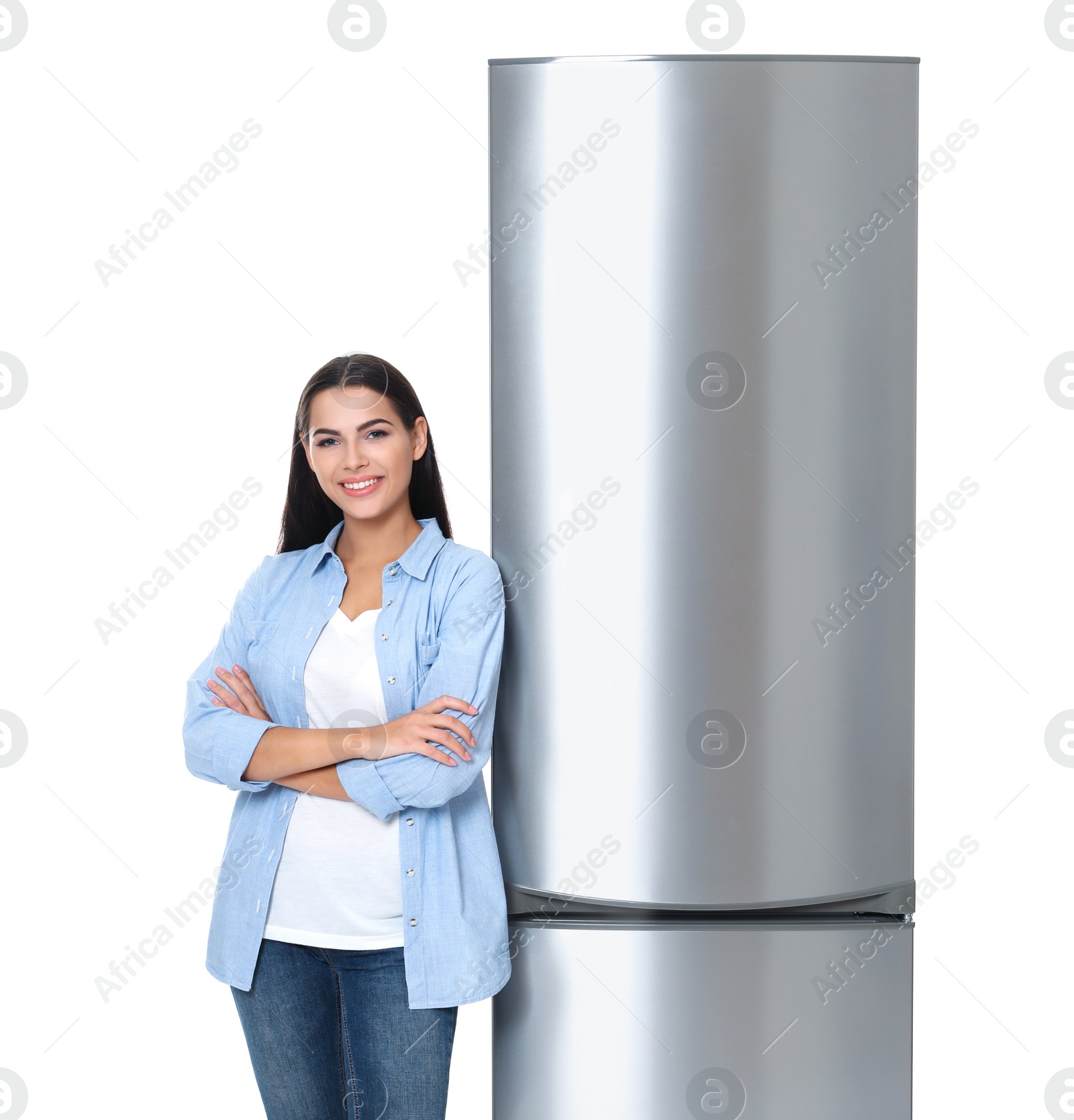 Photo of Young woman near closed refrigerator on white background