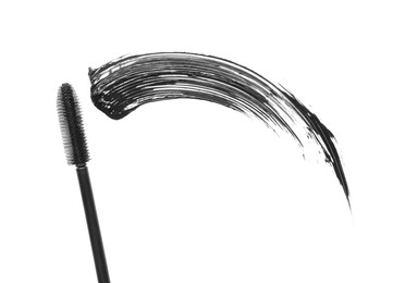 Photo of Smear of mascara and applicator isolated on white, top view