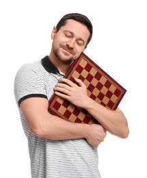 Handsome man with chessboard on white background