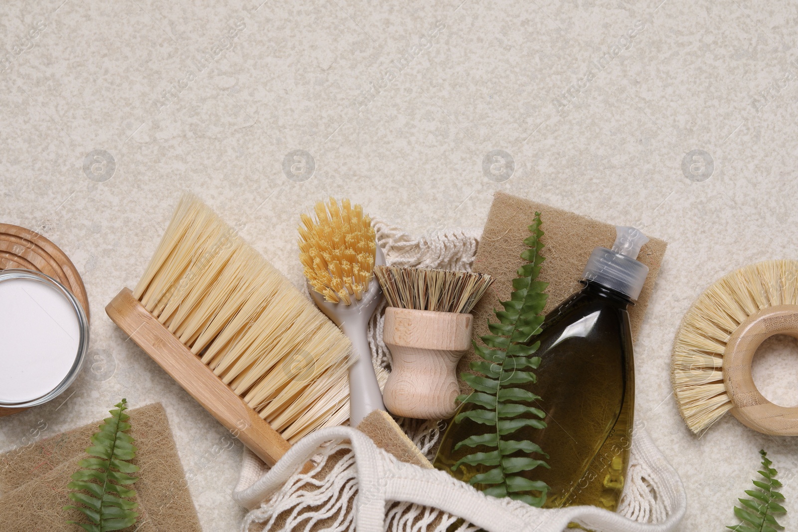 Photo of Flat lay composition with different cleaning supplies on beige background, space for text