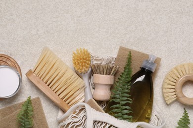 Photo of Flat lay composition with different cleaning supplies on beige background, space for text