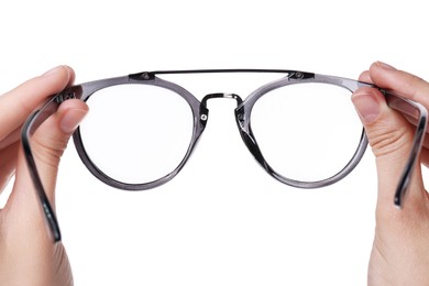 Photo of Woman holding stylish glasses with grey frame on white background, closeup