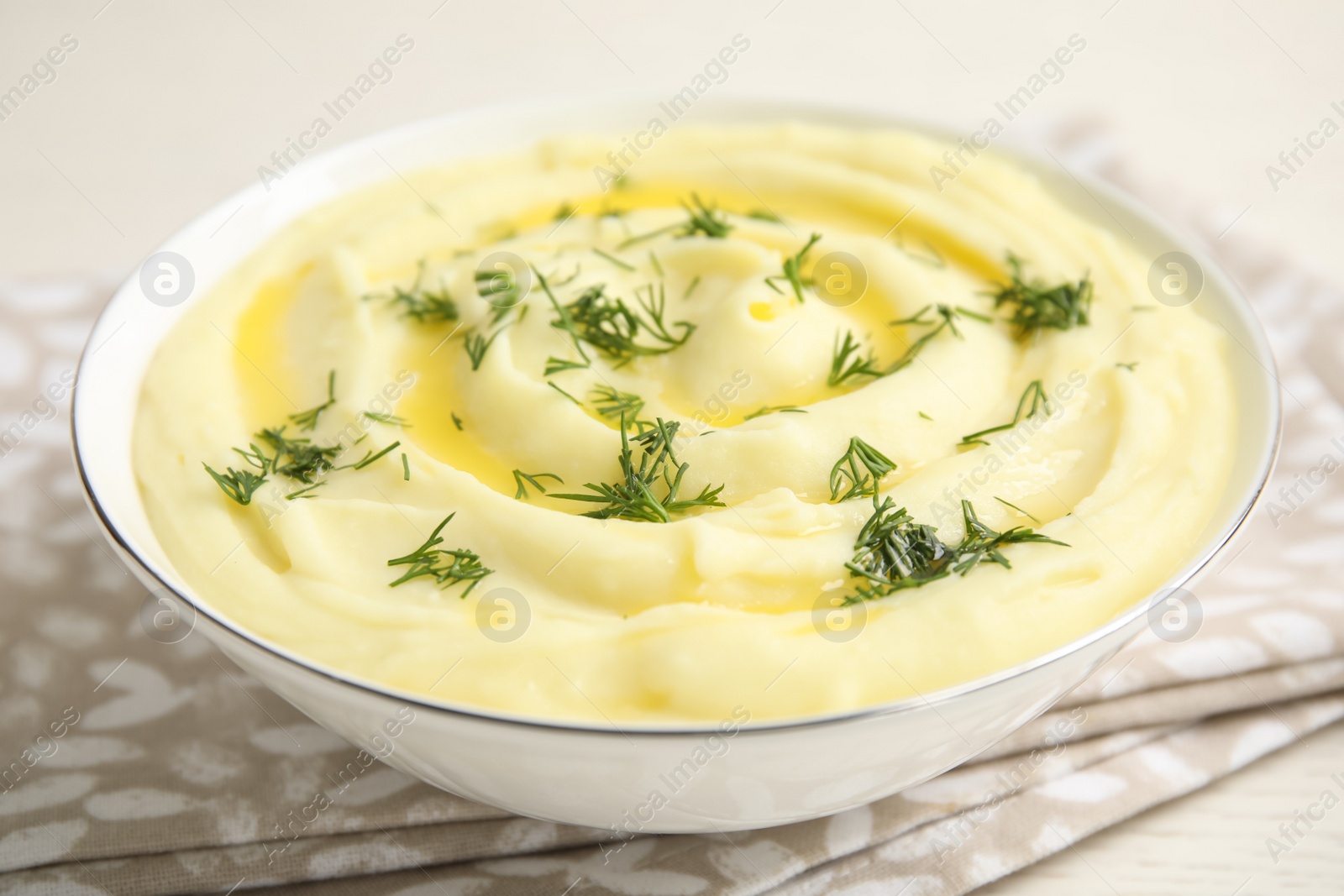 Photo of Freshly cooked homemade mashed potatoes on white table, closeup