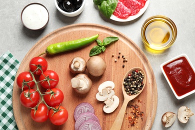 Photo of Flat lay composition with fresh ingredients for pizza on grey table