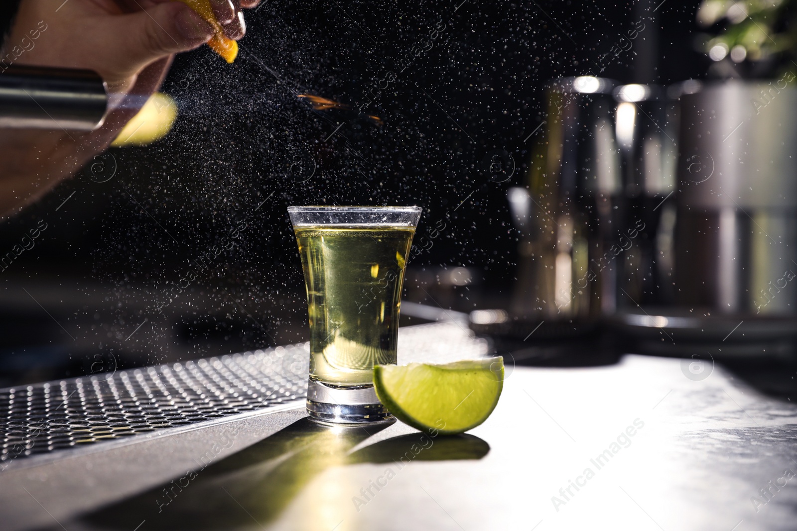 Photo of Mexican Tequila shot with lime slice on bar counter