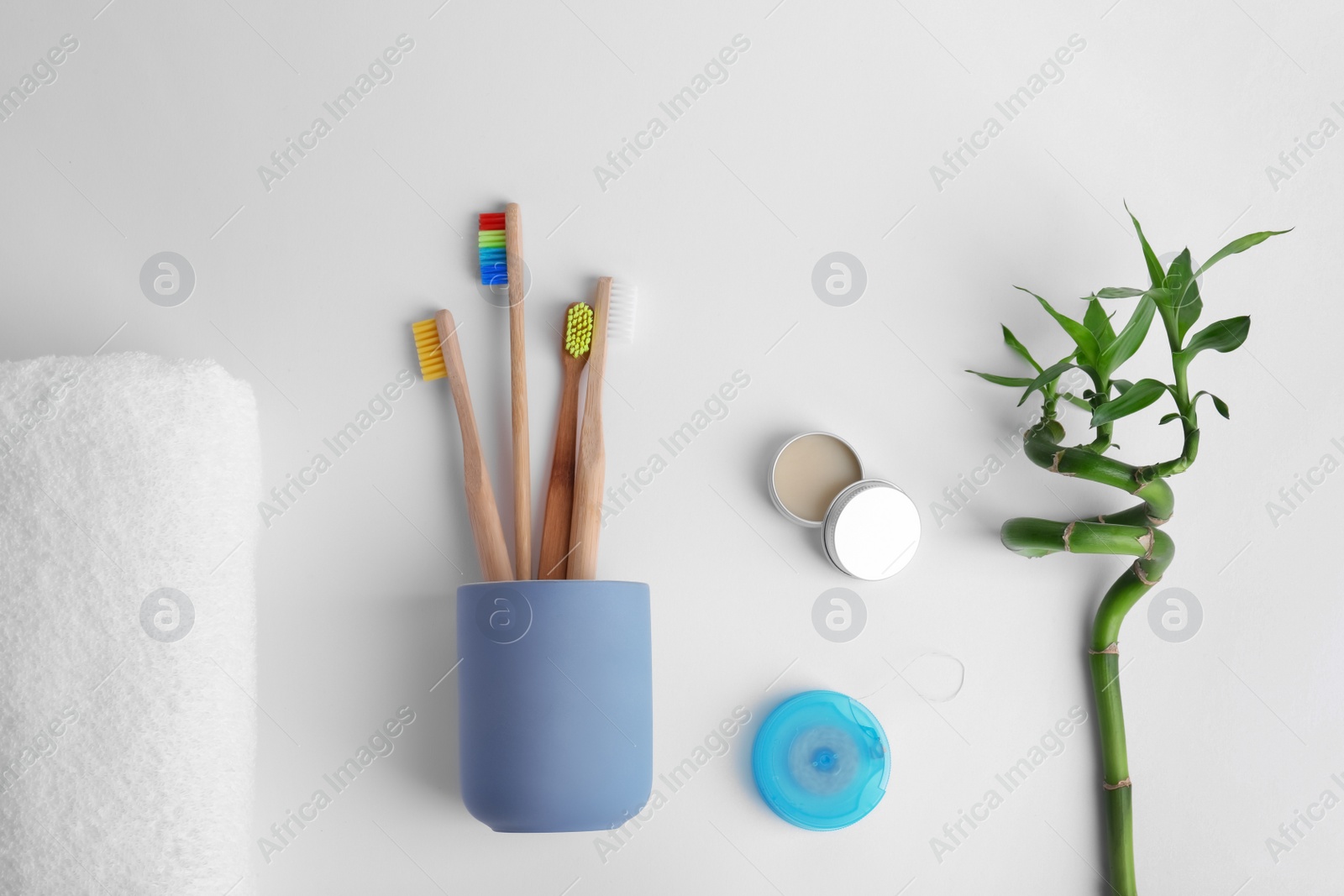 Photo of Flat lay composition with bamboo toothbrushes and toiletries on white background