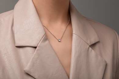 Photo of Woman with elegant necklace on dark grey background, closeup