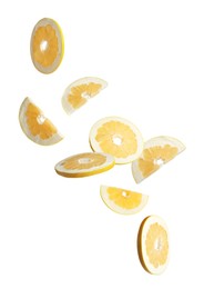 Fresh pomelo fruit slices falling on white background