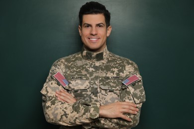Photo of Portrait of happy cadet near chalkboard. Military education