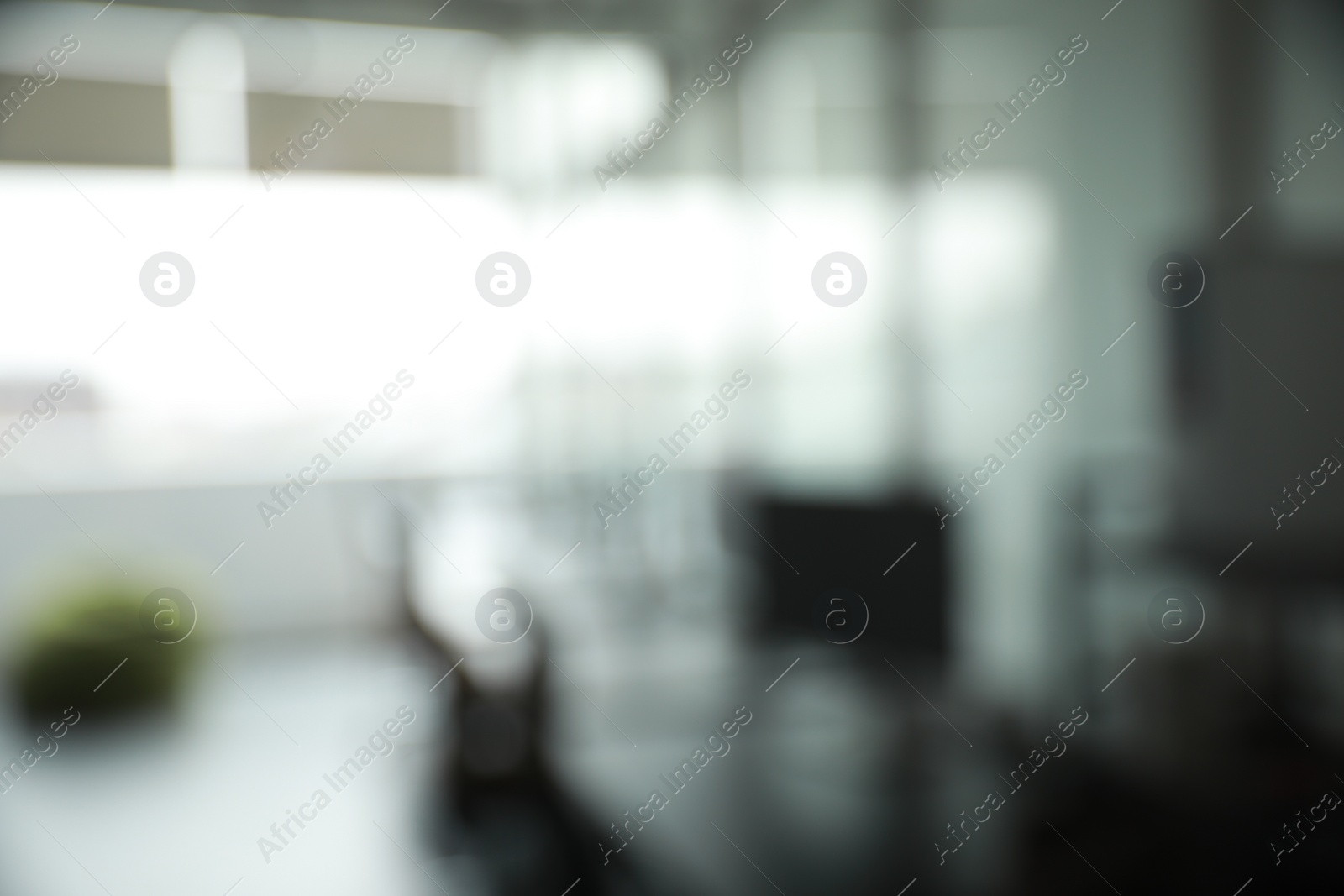 Photo of Blurred view of cozy workspaces with tables and chairs in office