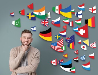 Image of Portrait of interpreter and flags of different countries on grey background