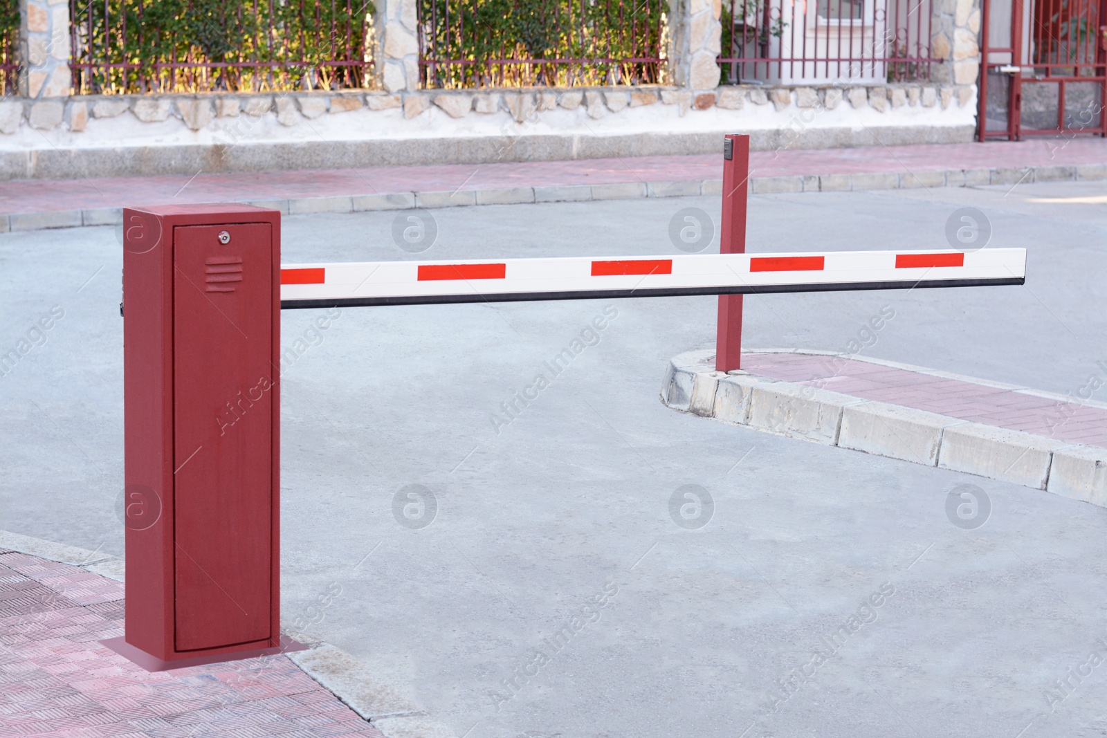 Photo of Closed boom barrier near road on autumn day outdoors