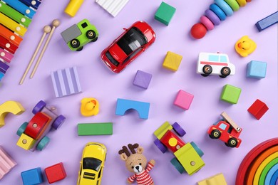 Photo of Different children's toys on violet background, flat lay