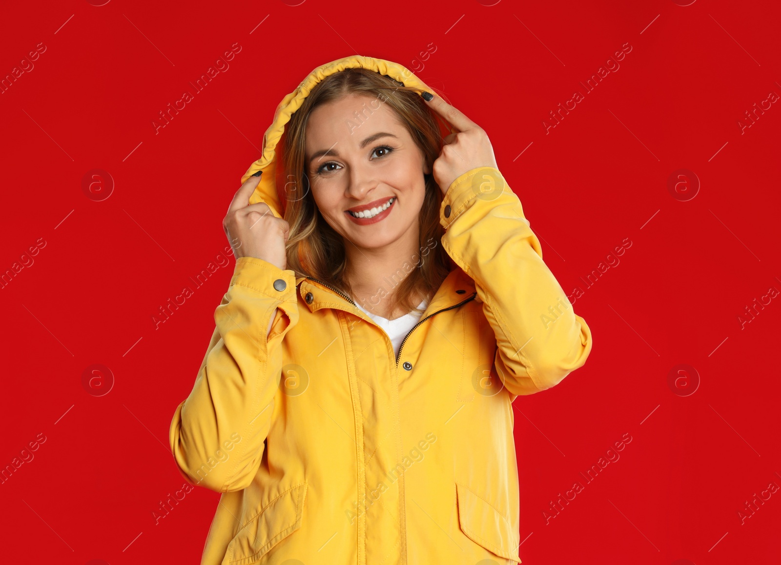 Photo of Beautiful woman in casual outfit on red background