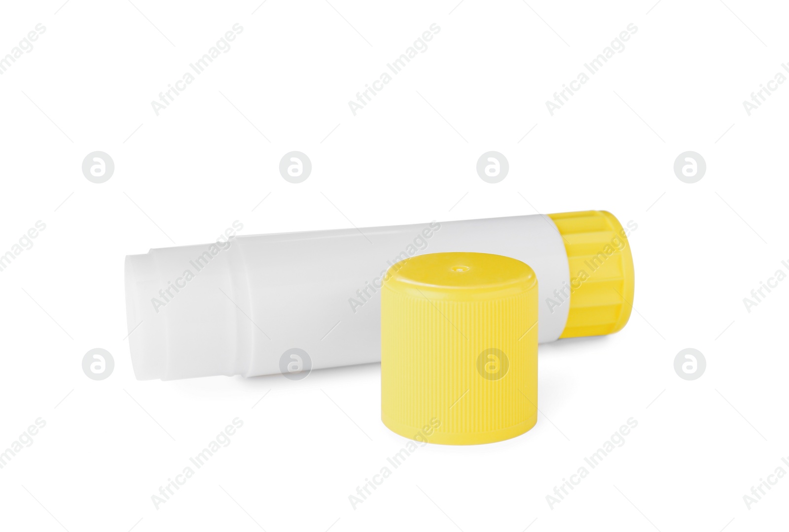 Photo of Open blank glue stick with yellow cap on white background