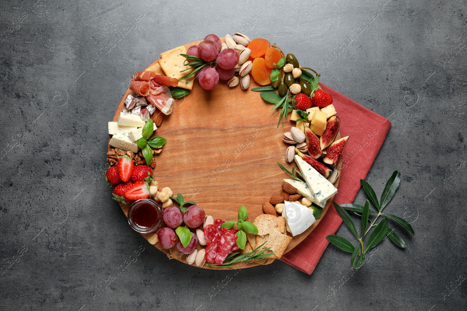 Photo of Different tasty appetizers on dark grey table, flat lay