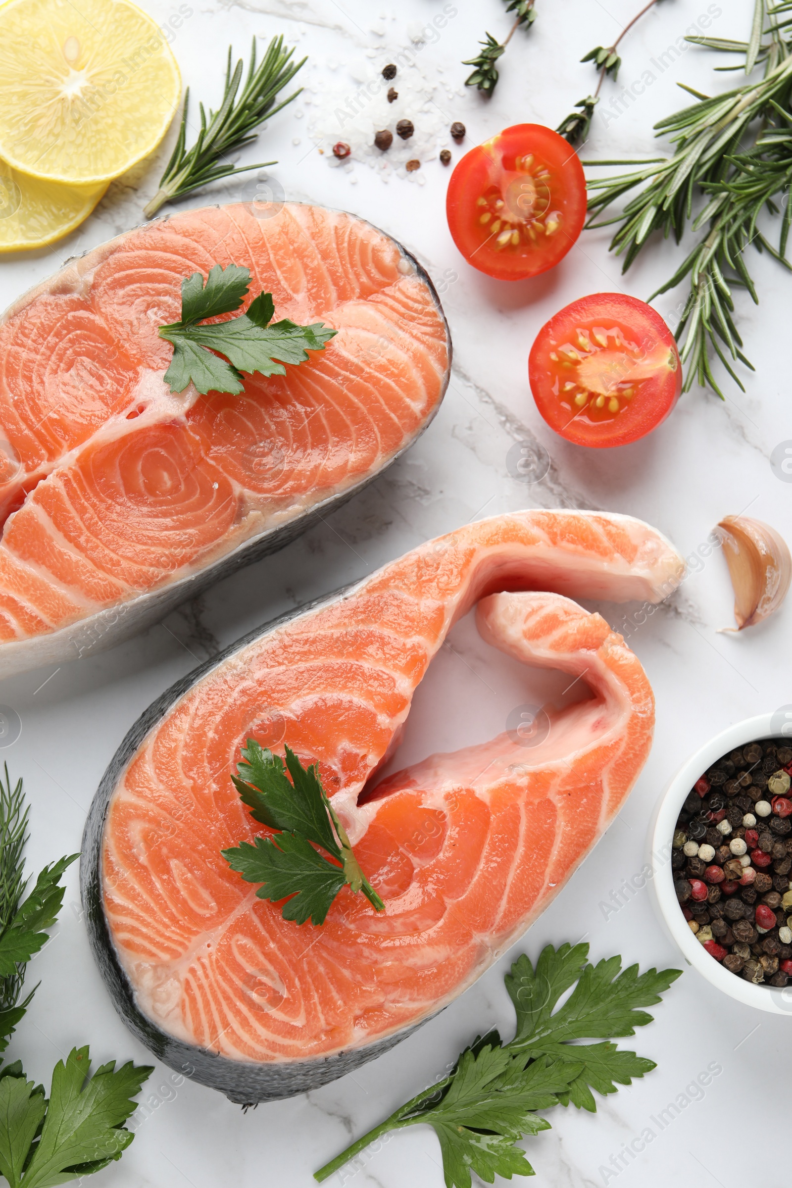 Photo of Fresh salmon and ingredients for marinade on white marble table, flat lay