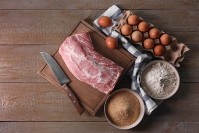 Different ingredients for cooking schnitzel on wooden table, flat lay