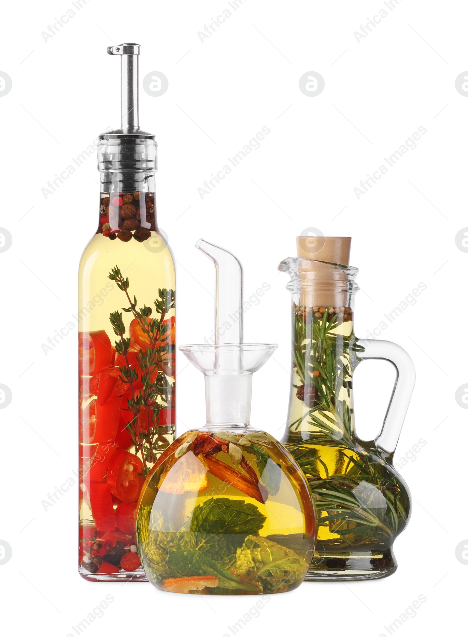Photo of Different sorts of cooking oil with spices and herbs in bottles on white background