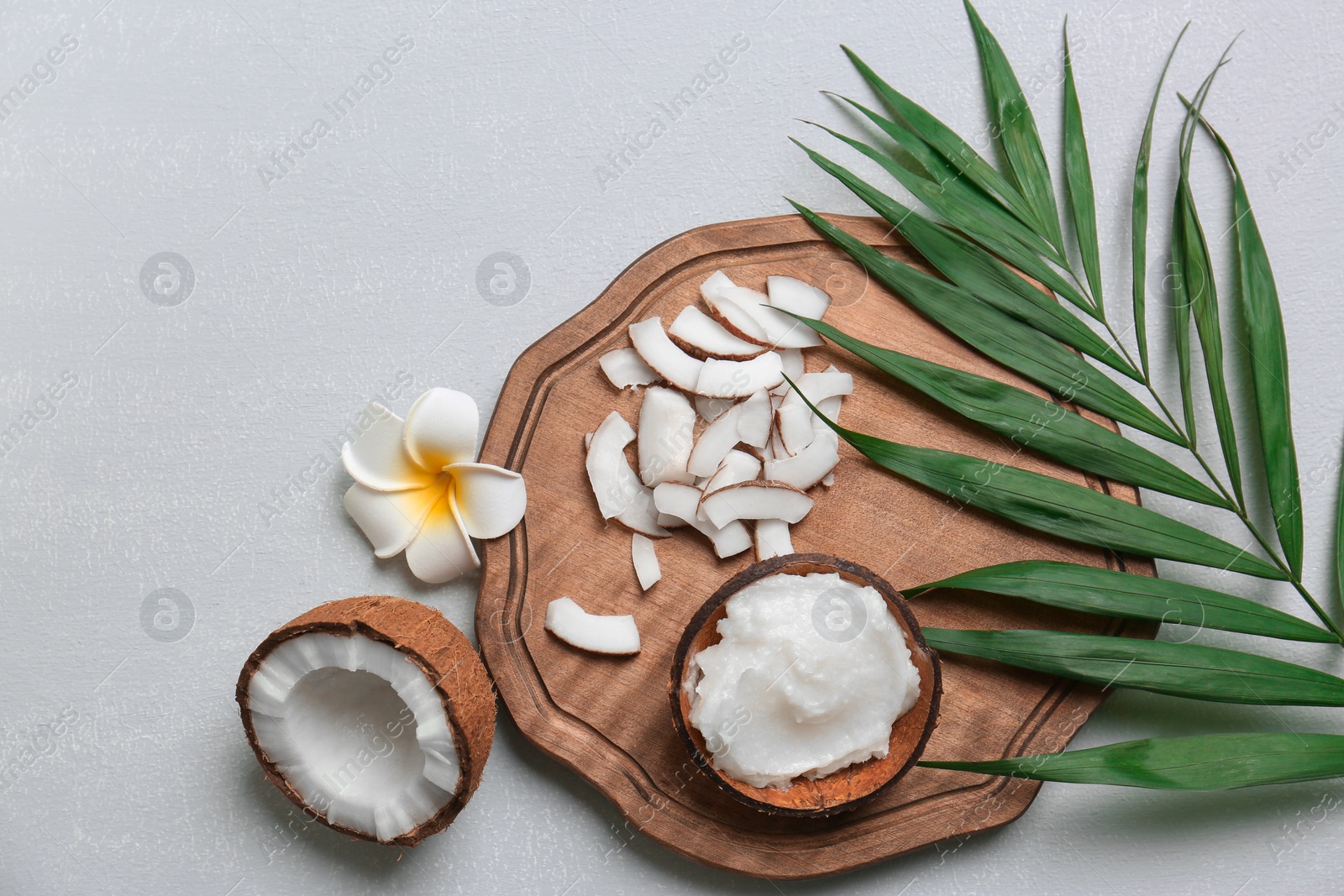 Photo of Beautiful composition with coconut oil and nuts on grey background