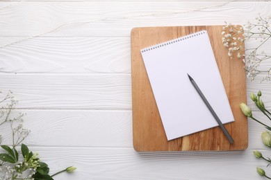 Photo of Guest list. Notebook, pencil and beautiful flowers on white wooden background, flat lay. Space for text