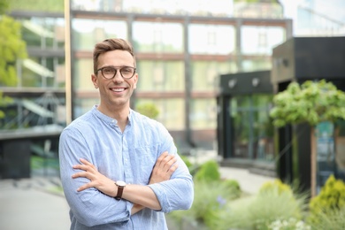 Portrait of attractive young man in stylish outfit outdoors