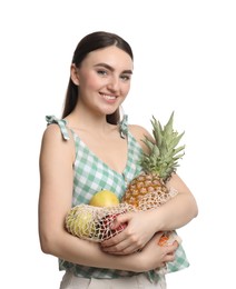Woman with string bag of fresh fruits on white background