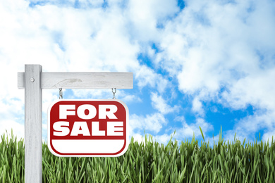 Image of Red real estate sign with inscription FOR SALE outdoors on sunny day, space for text 
