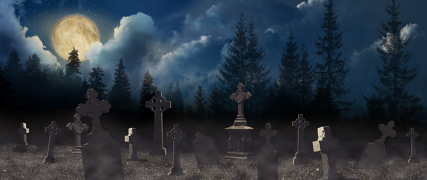 Image of Misty cemetery with old creepy headstones under full moon. Halloween banner design