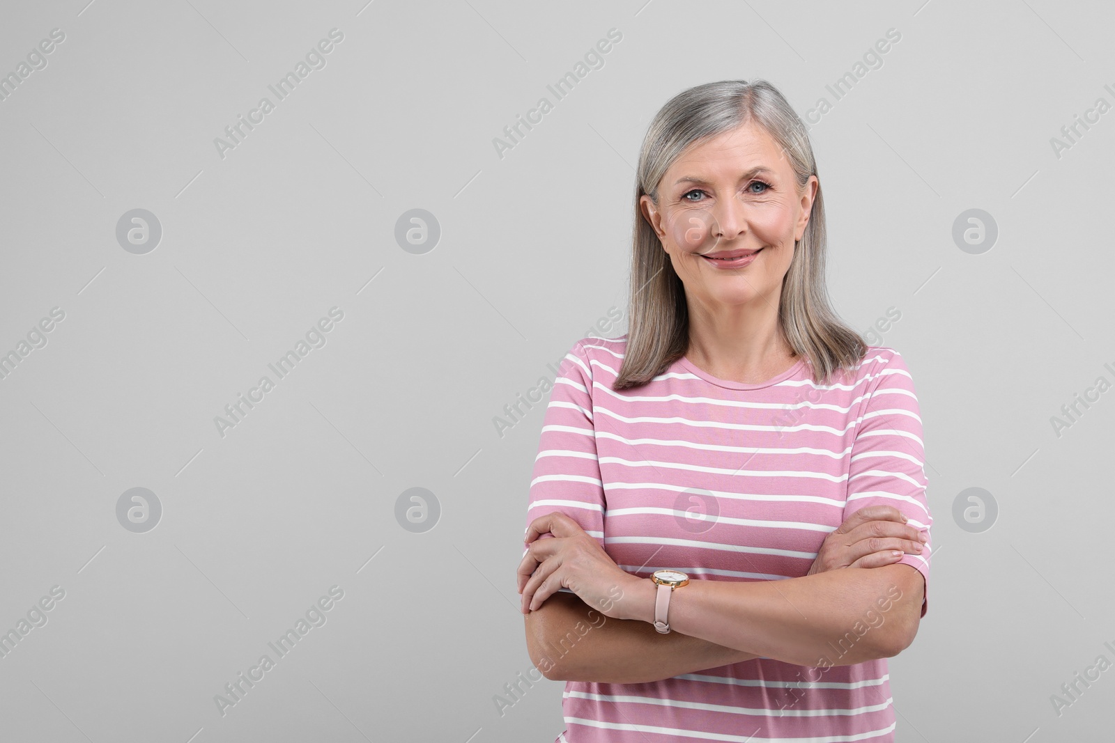 Photo of Portrait of beautiful senior woman on light grey background. Space for text