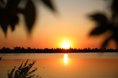 Photo of Picturesque view of tranquil river at sunset