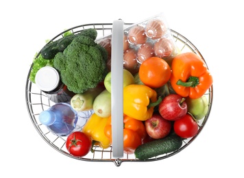 Photo of Shopping basket with grocery products on white background, top view