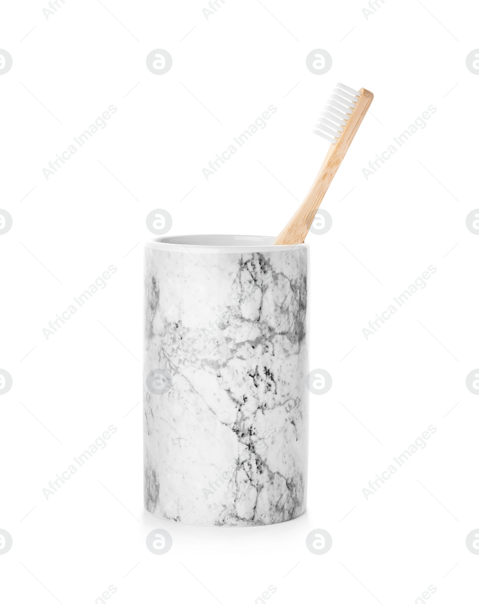 Photo of Bamboo toothbrush in holder on white background. Dental care