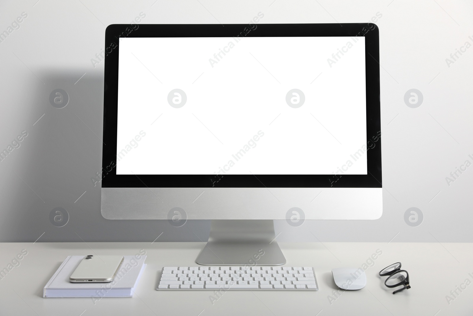 Photo of Workplace with modern computer and smartphone on white table. Mockup for design