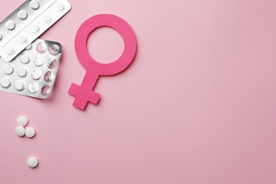 Photo of Female gender sign, pills and space for text on pink background, flat lay. Women's health concept