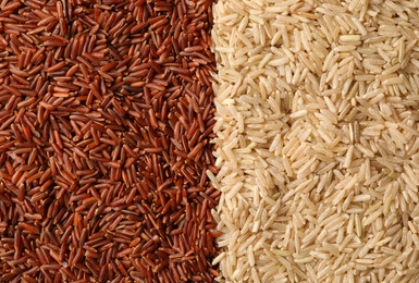 Different types of brown rice as background, top view