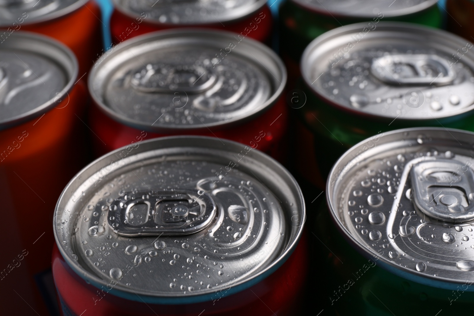 Photo of Energy drinks in wet cans, closeup. Functional beverage