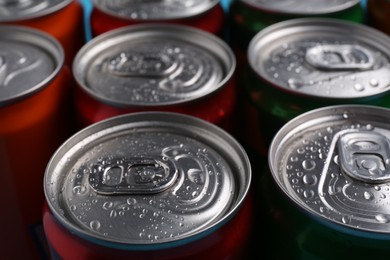 Photo of Energy drinks in wet cans, closeup. Functional beverage