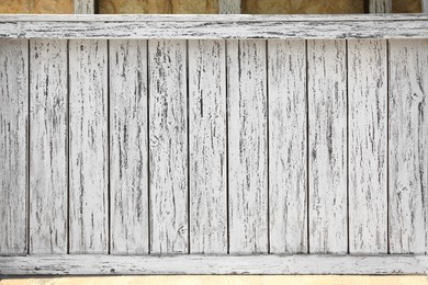 Closeup view of white wooden fence outdoors on sunny day
