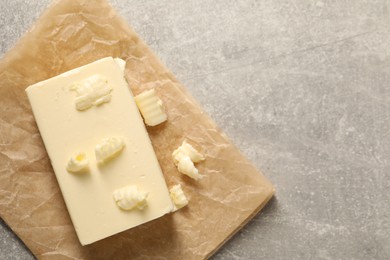 Photo of Tasty butter on grey table, top view. Space for text